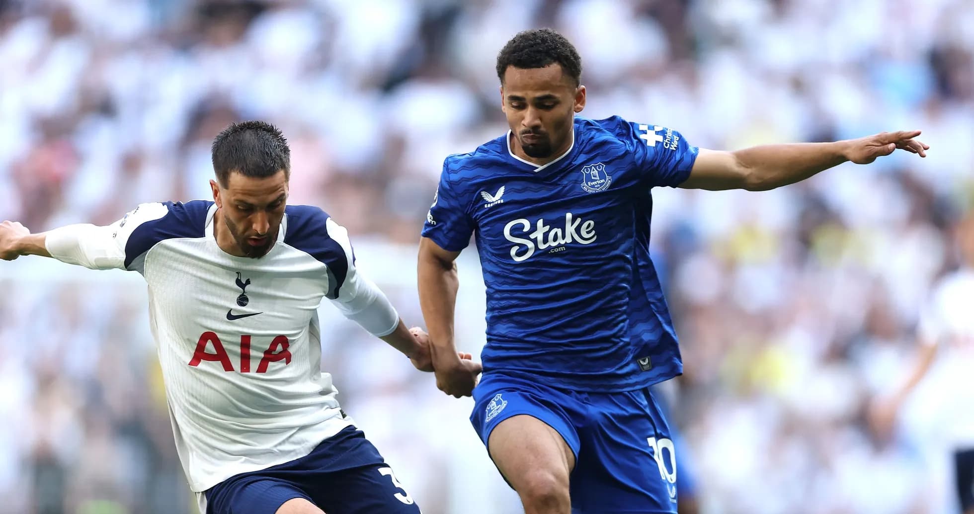 Tottenham and Everton players competing for the ball Tottenham and Everton players competing for the ball