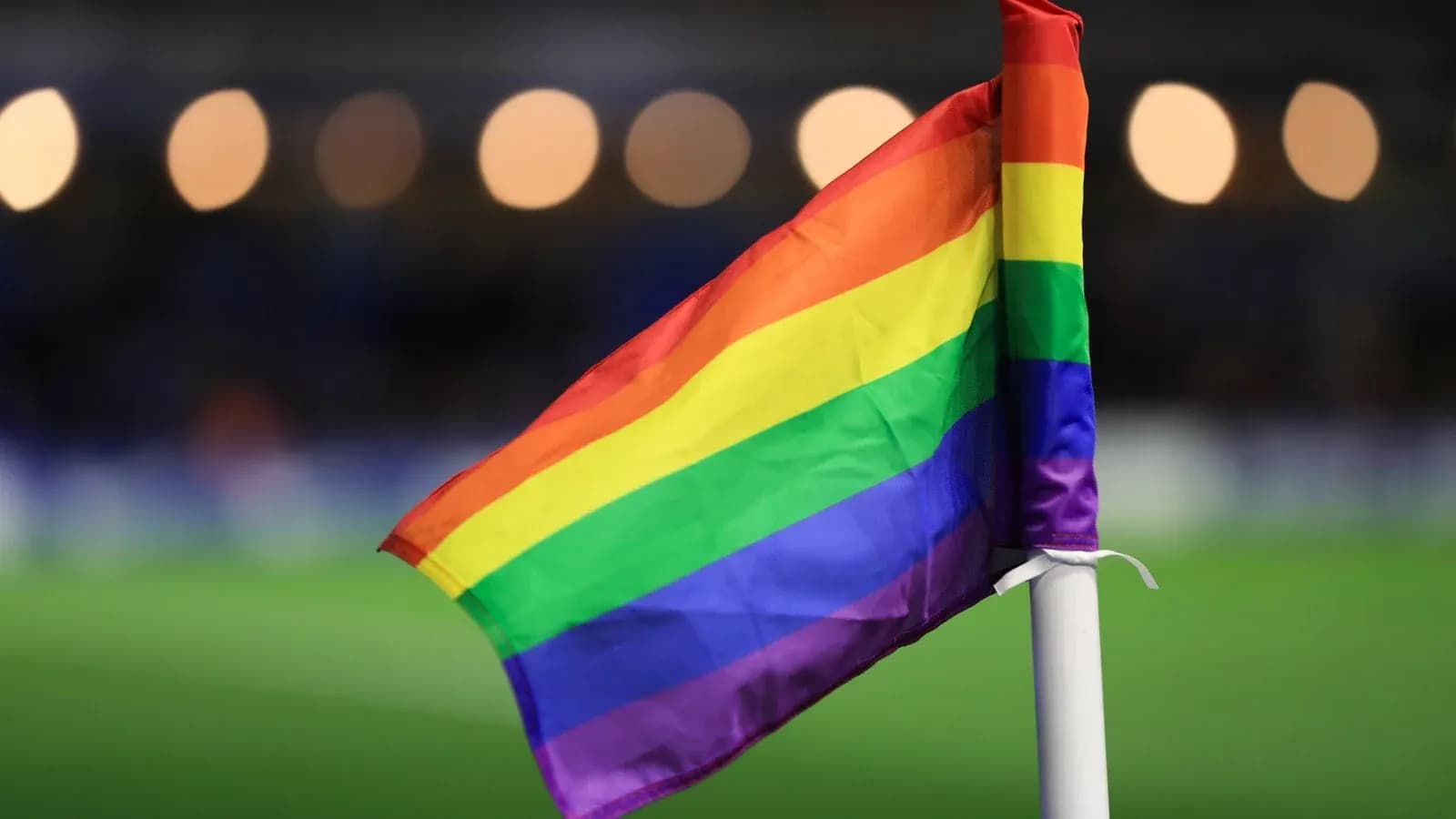 Pride flag on corner flag at football match Pride flag on corner flag at football match