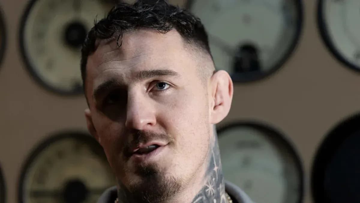 Man with tattoos speaking in front of gauges Man with tattoos speaking in front of gauges