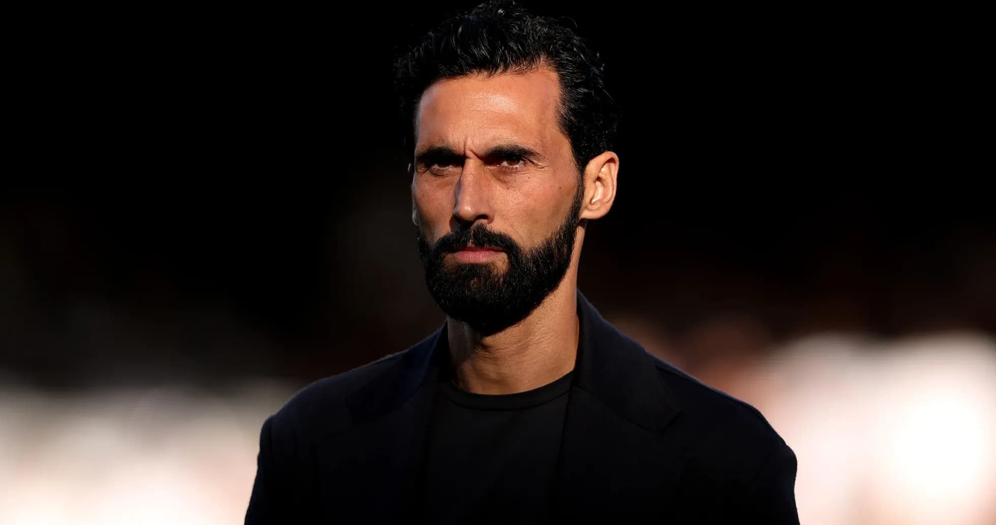Bearded man in dark clothing looking serious Bearded man in dark clothing looking serious