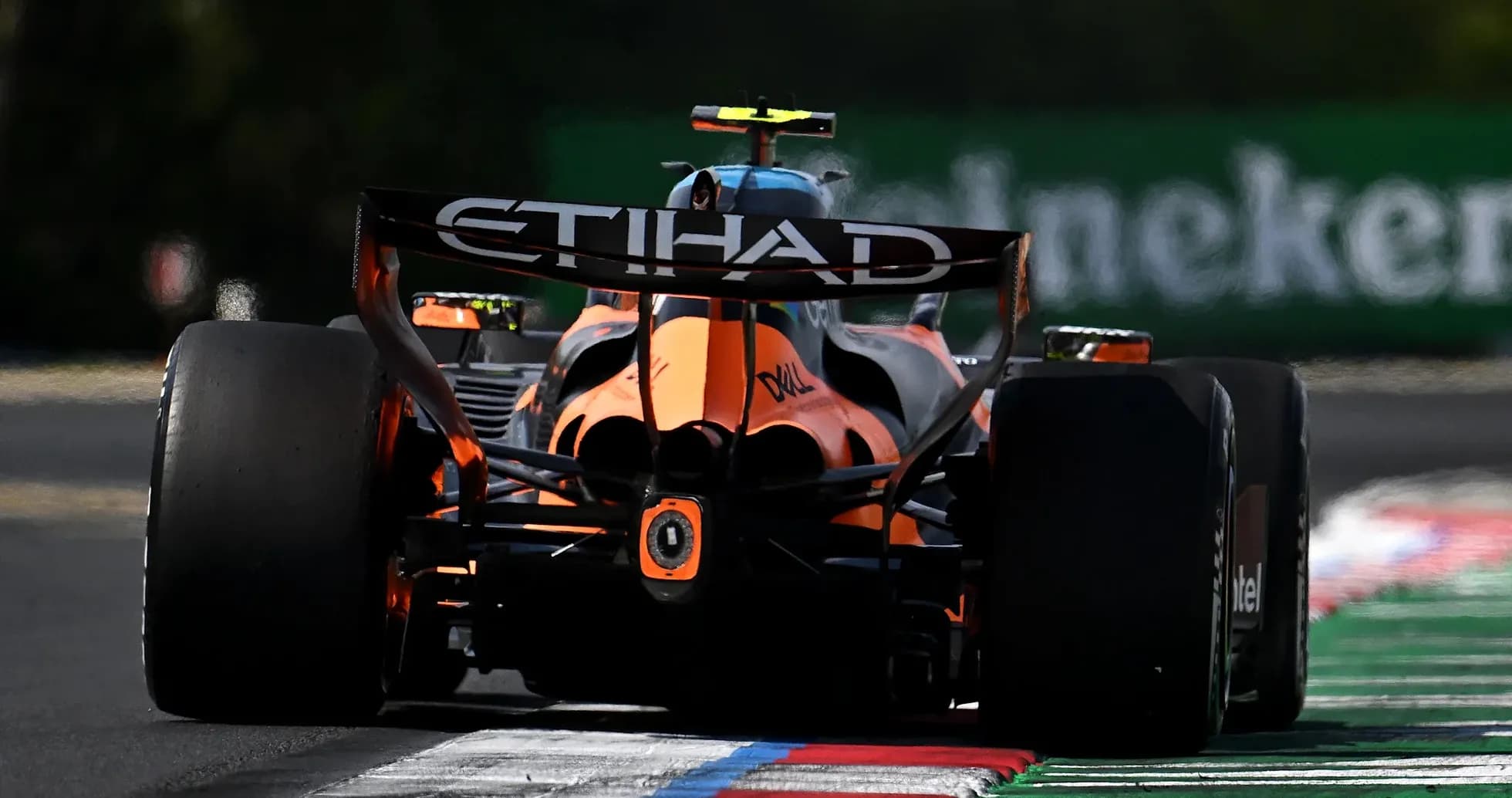 F1 car racing on track with colorful curbing F1 car racing on track with colorful curbing