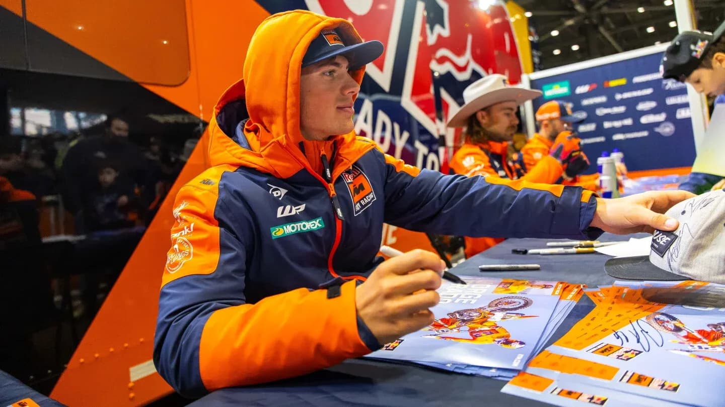 Rider signing autographs at promotional event Rider signing autographs at promotional event