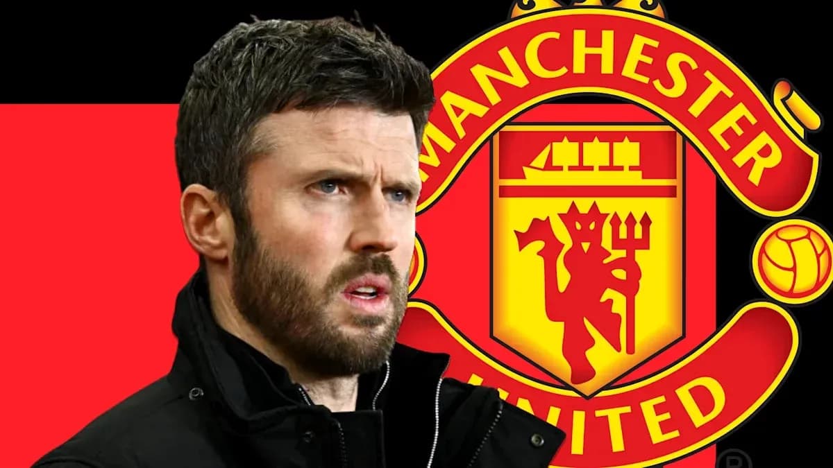 Men's football coach in front of Manchester United logo Men's football coach in front of Manchester United logo