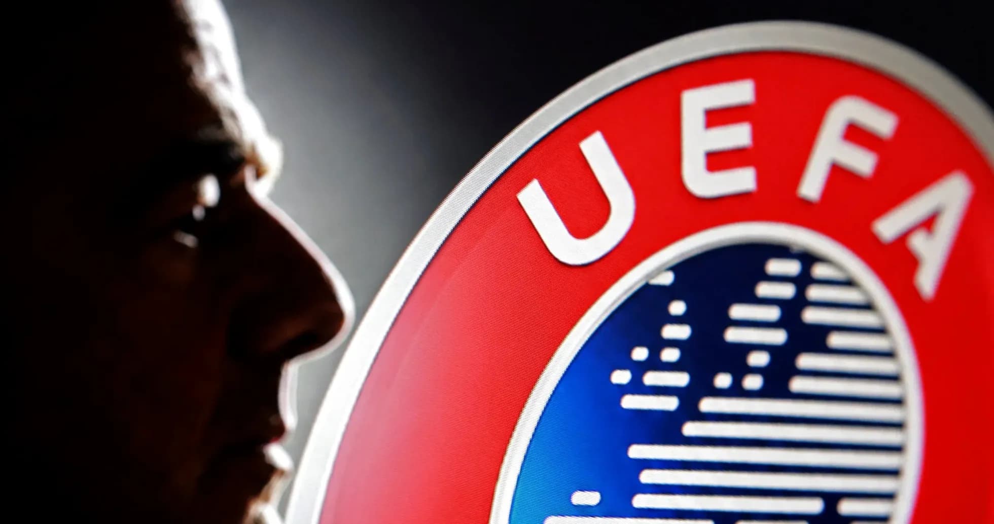 Silhouette of a person next to UEFA logo Silhouette of a person next to UEFA logo