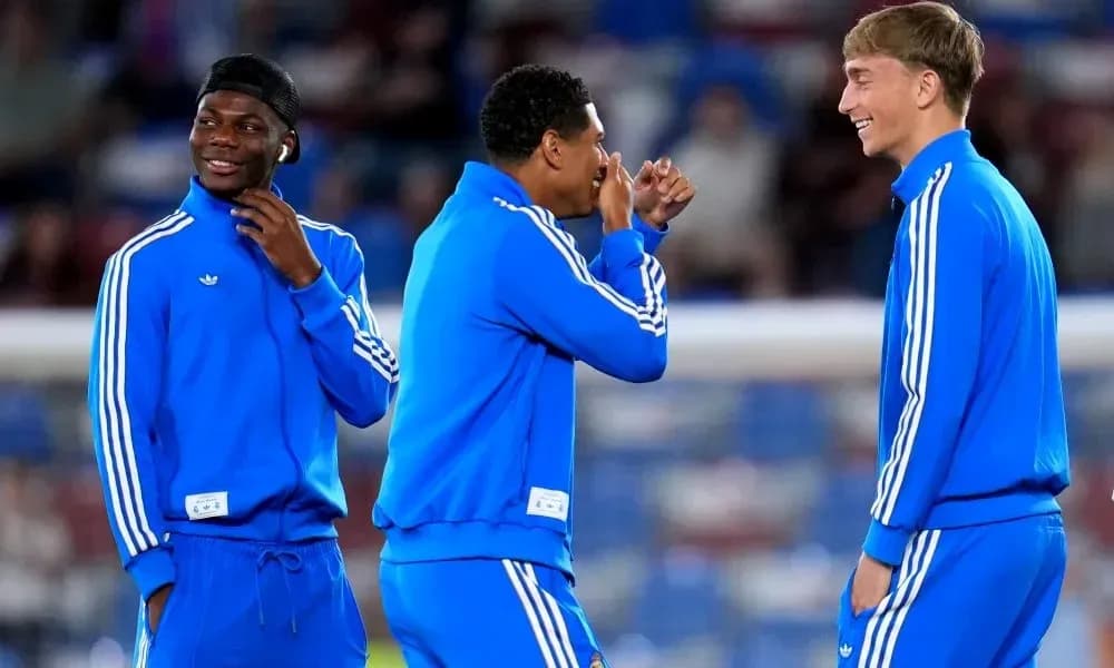 Three players in blue tracksuits during warm-up Three players in blue tracksuits during warm-up