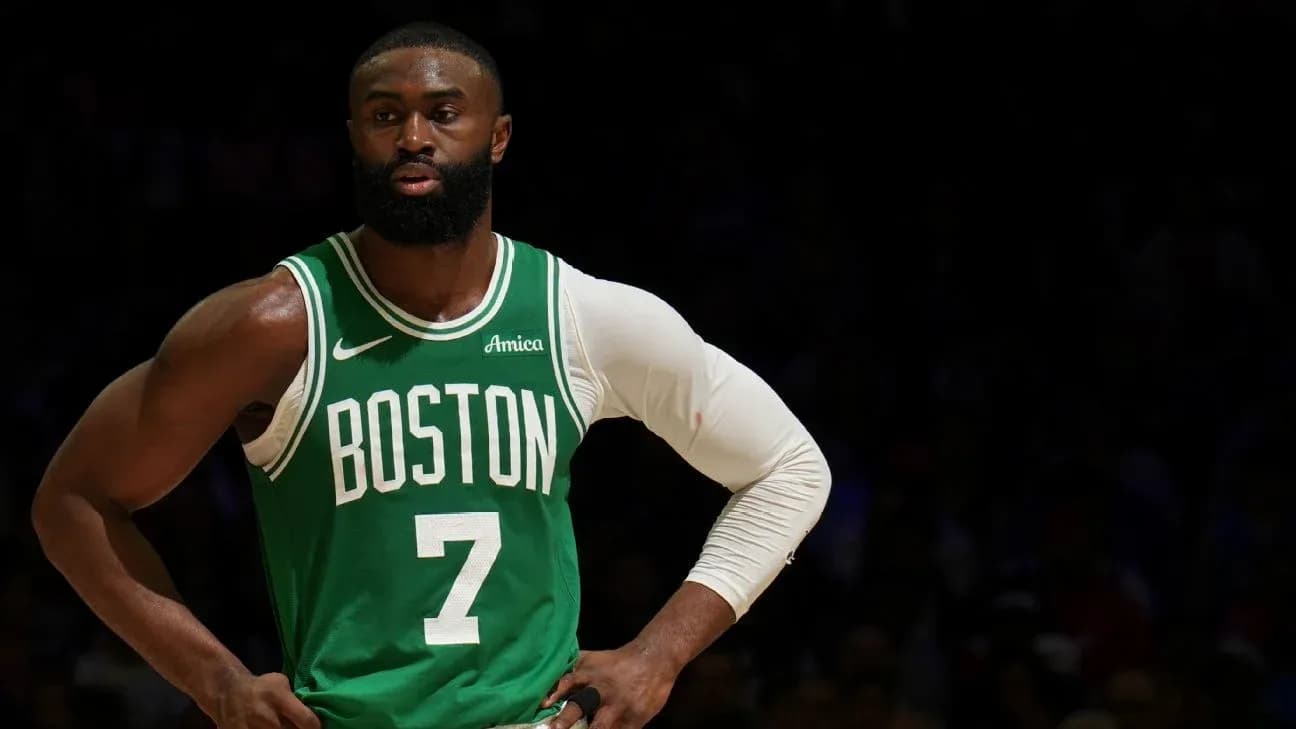 Basketball player in Boston Celtics uniform on court Basketball player in Boston Celtics uniform on court