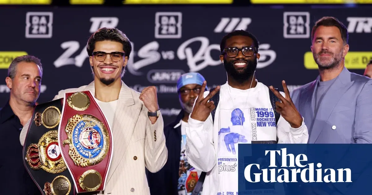 Boxers posing with championship belts at press conference Boxers posing with championship belts at press conference