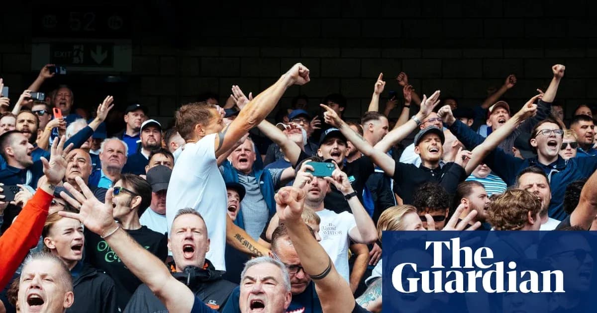 Fans cheering enthusiastically in a crowded stadium Fans cheering enthusiastically in a crowded stadium