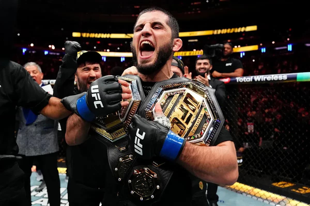 UFC champion celebrating with two championship belts UFC champion celebrating with two championship belts