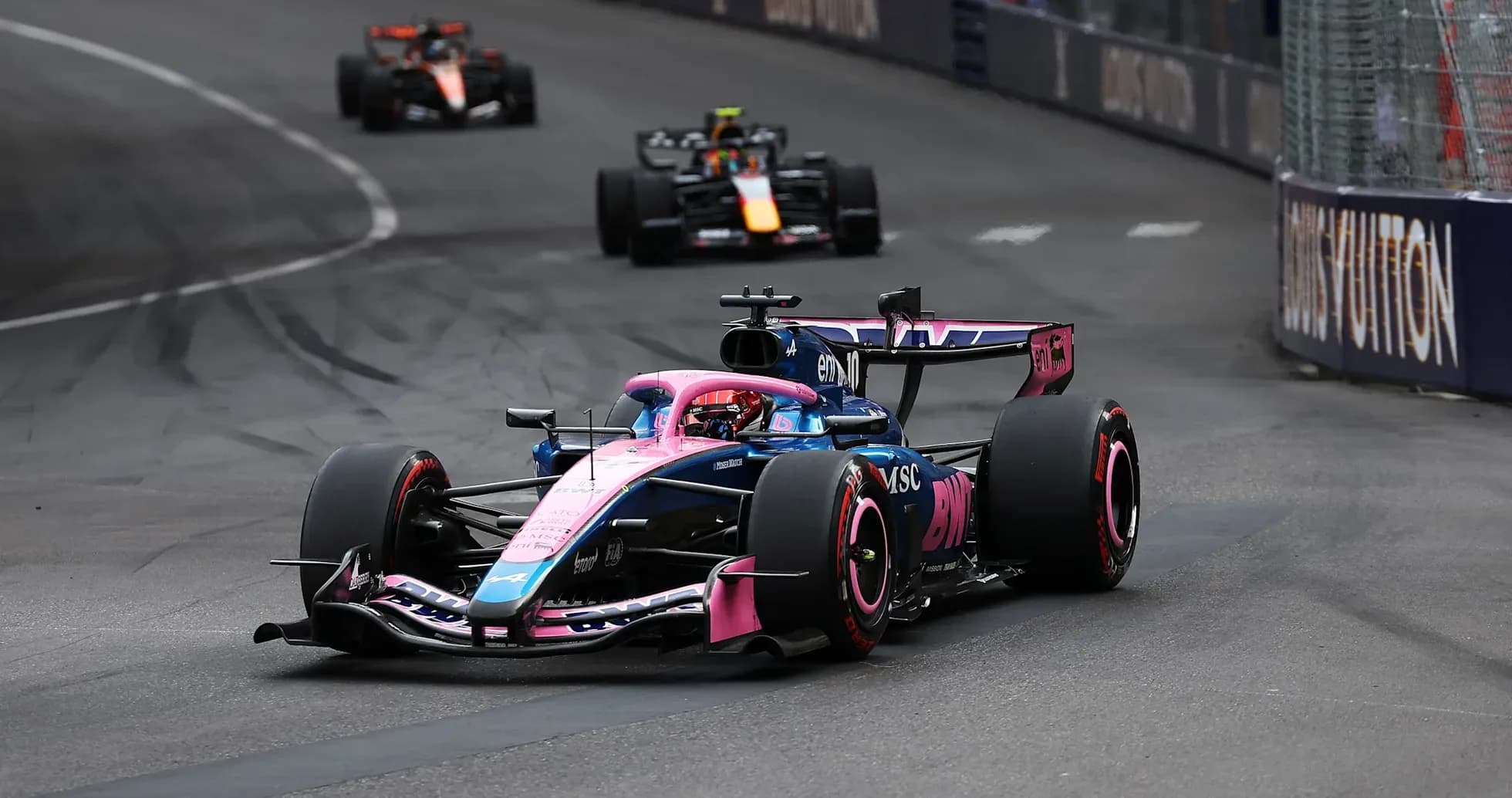 Formula 1 car racing around a corner on track Formula 1 car racing around a corner on track