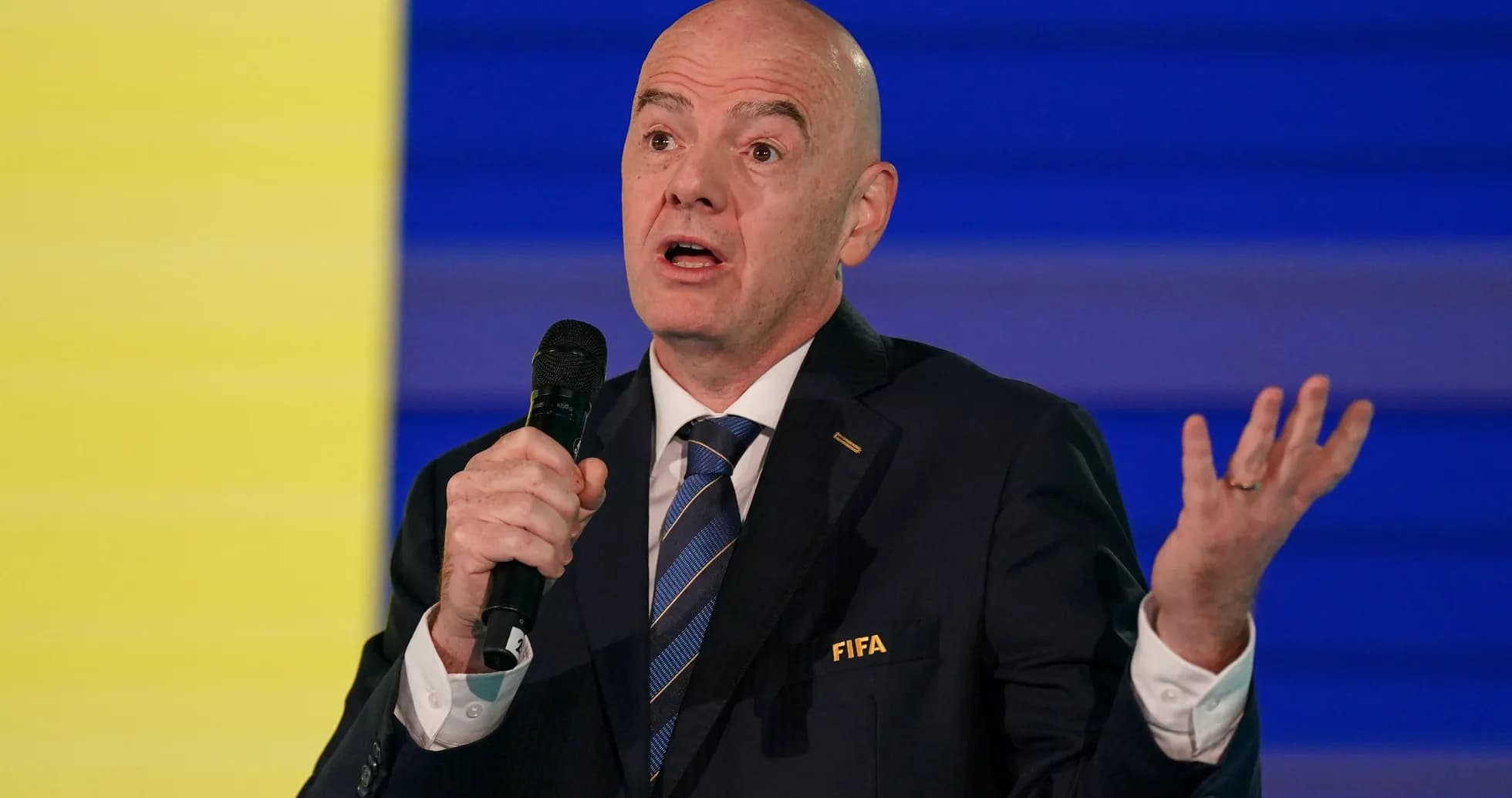 FIFA official speaking at a podium event FIFA official speaking at a podium event