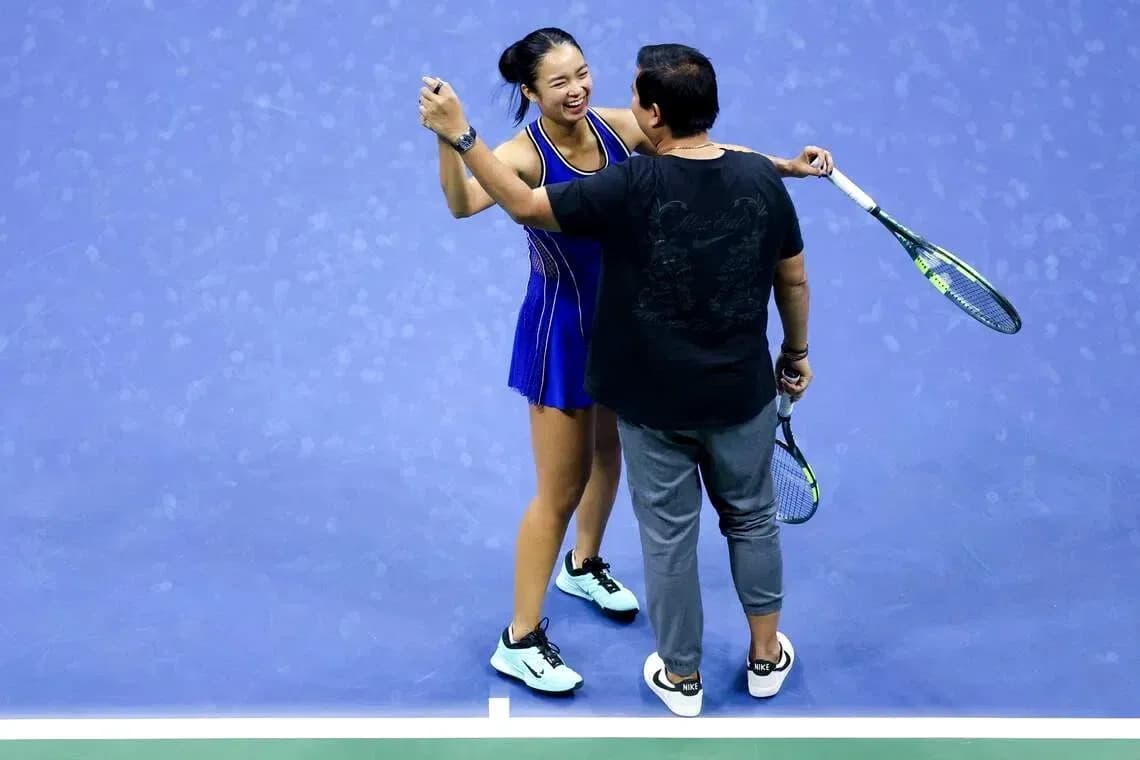 Tennis player celebrating with coach on court Tennis player celebrating with coach on court