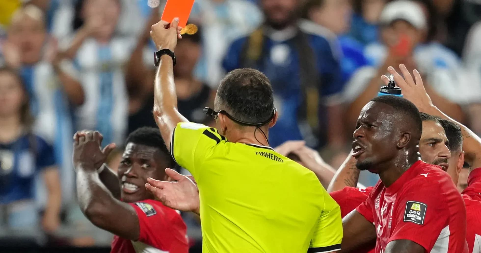 Referee shows red card to player during match Referee shows red card to player during match