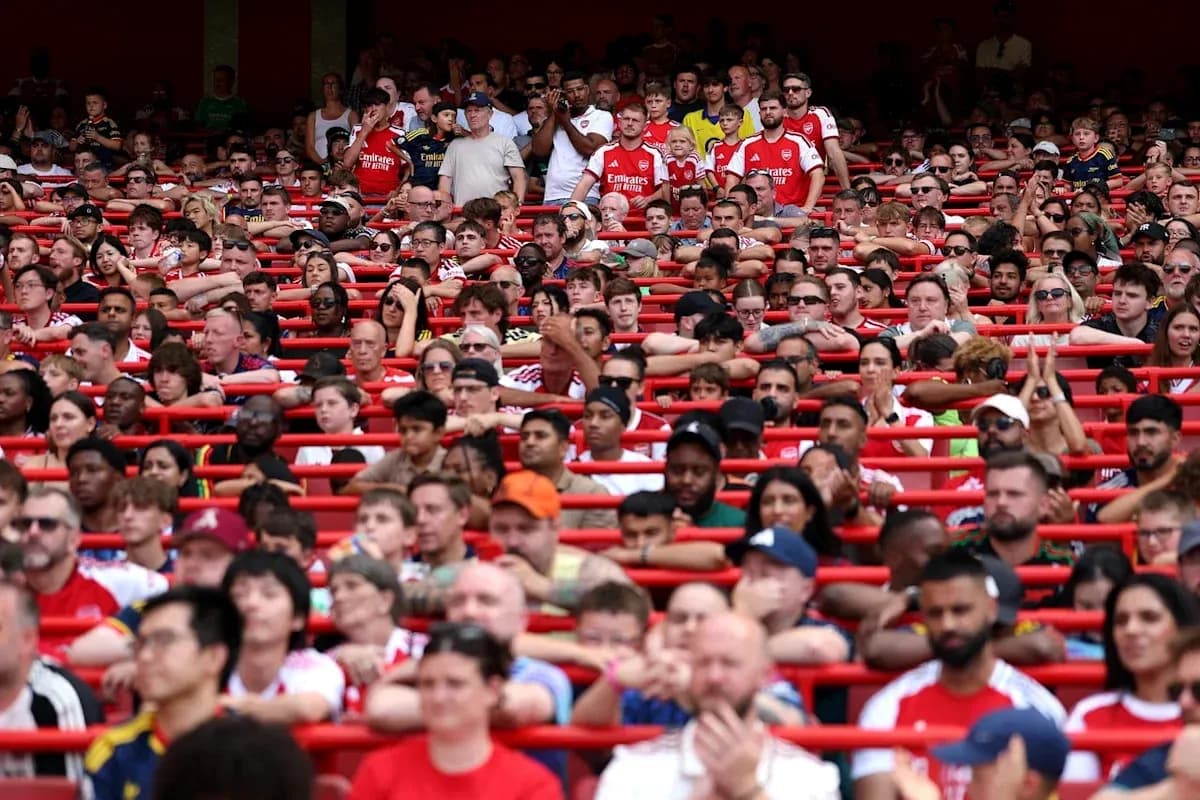 Arsenal fans in stadium during a match Arsenal fans in stadium during a match