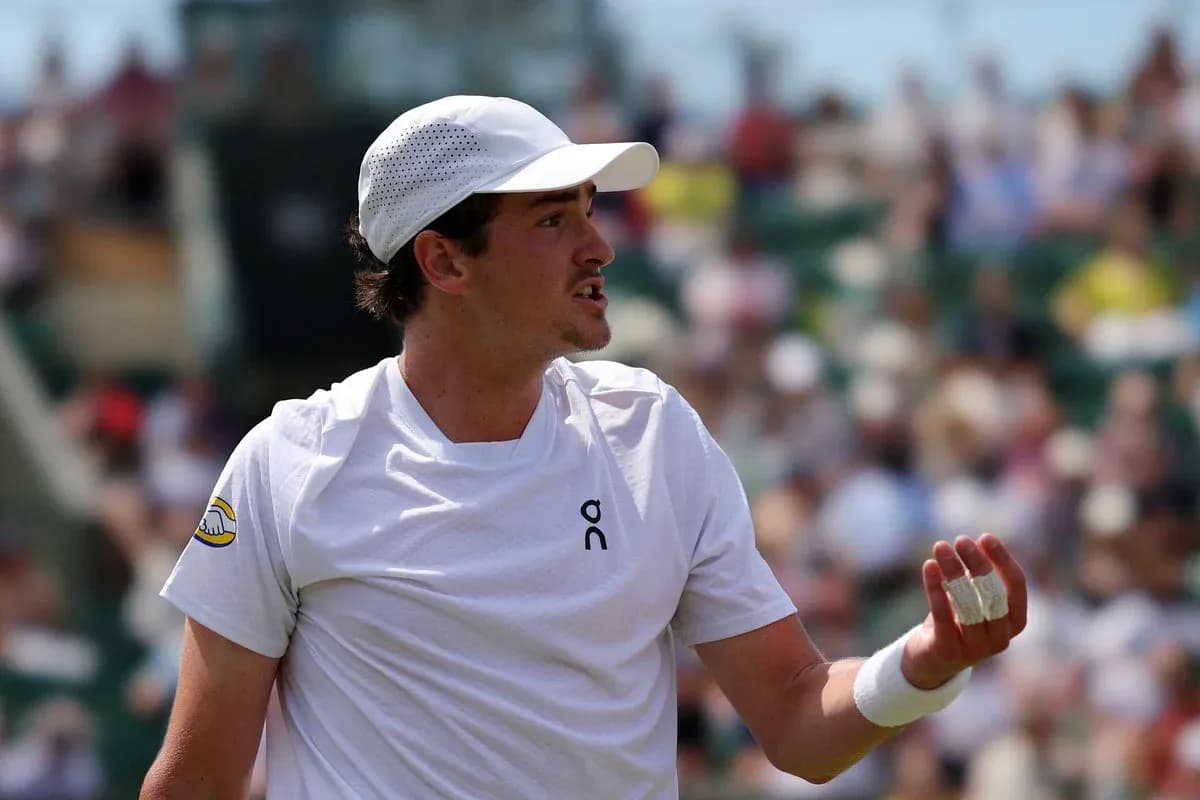 Tennis player gesturing during match on court Tennis player gesturing during match on court