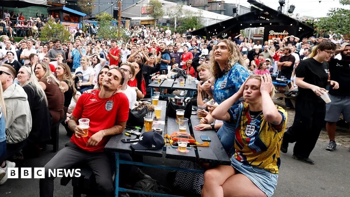Fans watching football match in crowded outdoor venue Fans watching football match in crowded outdoor venue