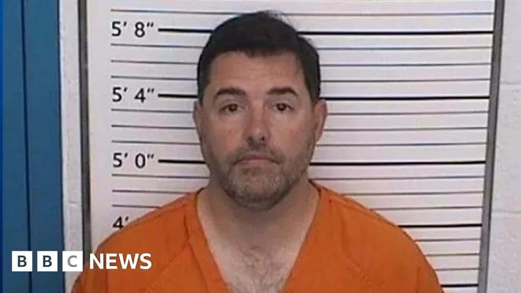 Man in orange jumpsuit at police station mugshot Man in orange jumpsuit at police station mugshot