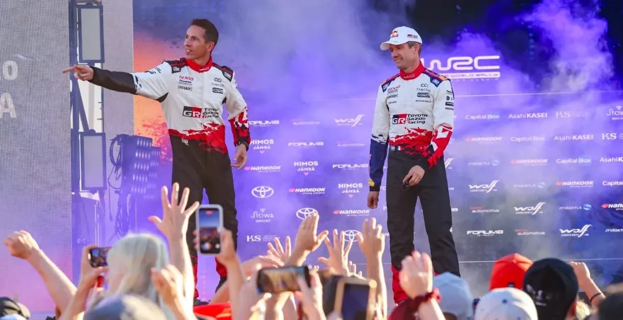 Rally drivers celebrating on stage with fans Rally drivers celebrating on stage with fans
