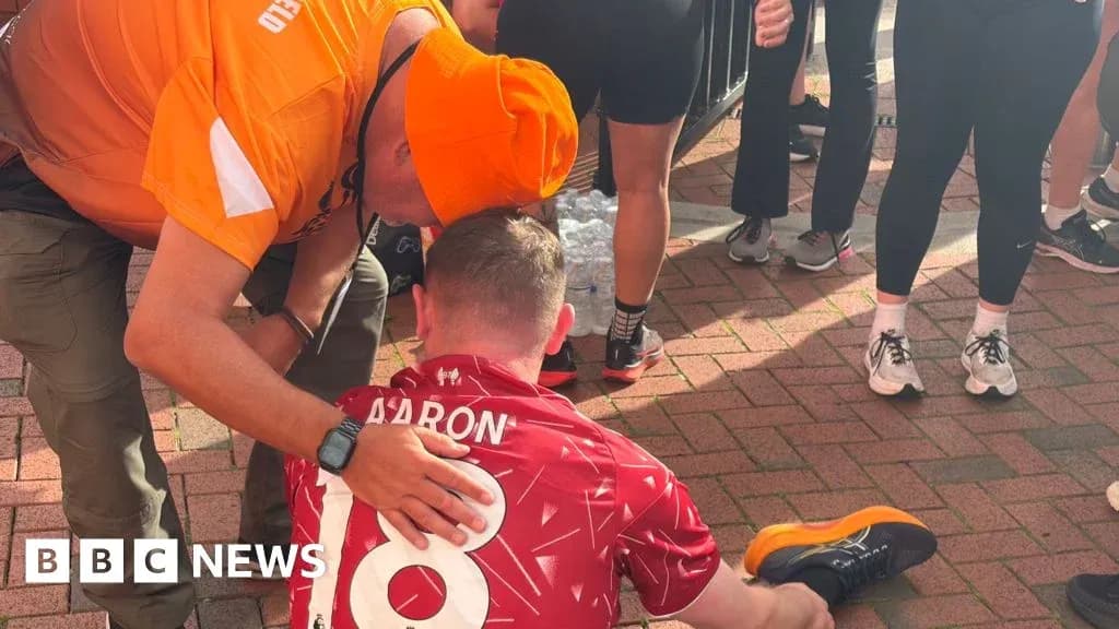 Supporter assisting athlete sitting on ground Supporter assisting athlete sitting on ground