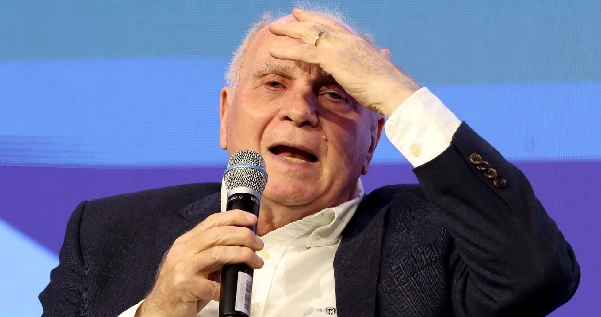 Speaker gesturing while holding microphone at event Speaker gesturing while holding microphone at event