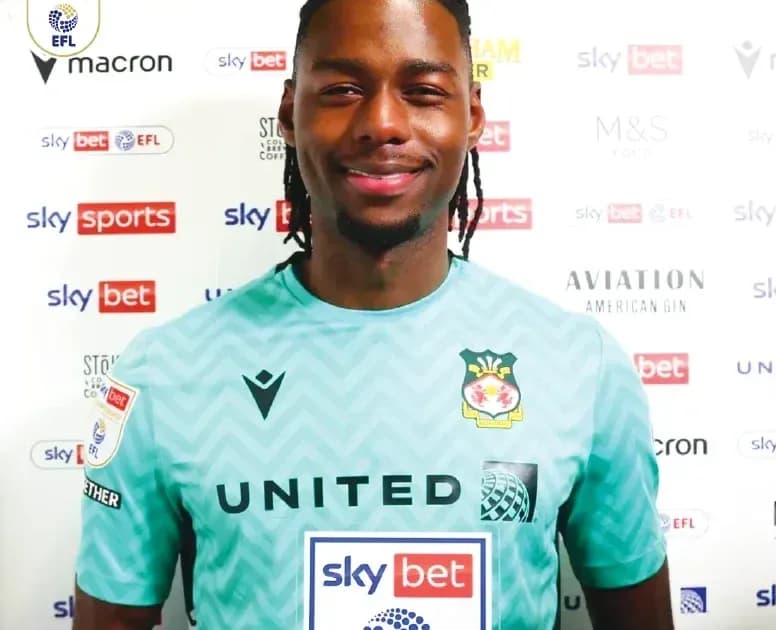 Football player in goalkeeper kit posing for photo Football player in goalkeeper kit posing for photo