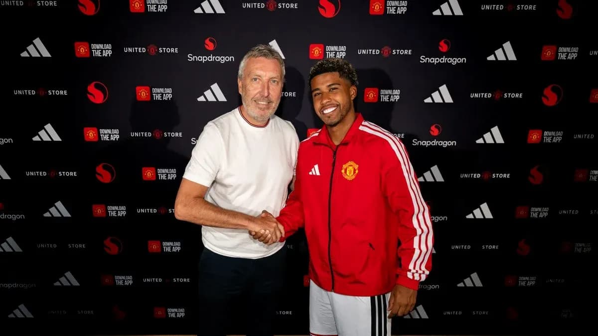 Two men shaking hands at Manchester United signing event Two men shaking hands at Manchester United signing event