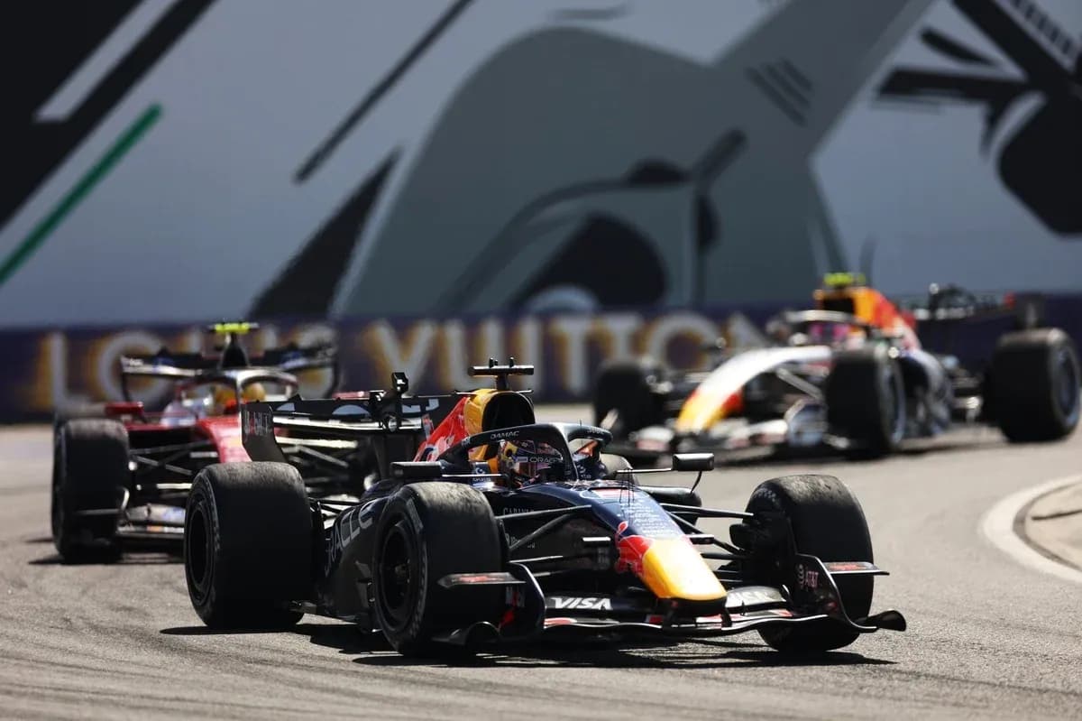 Formula 1 cars racing on a circuit track Formula 1 cars racing on a circuit track