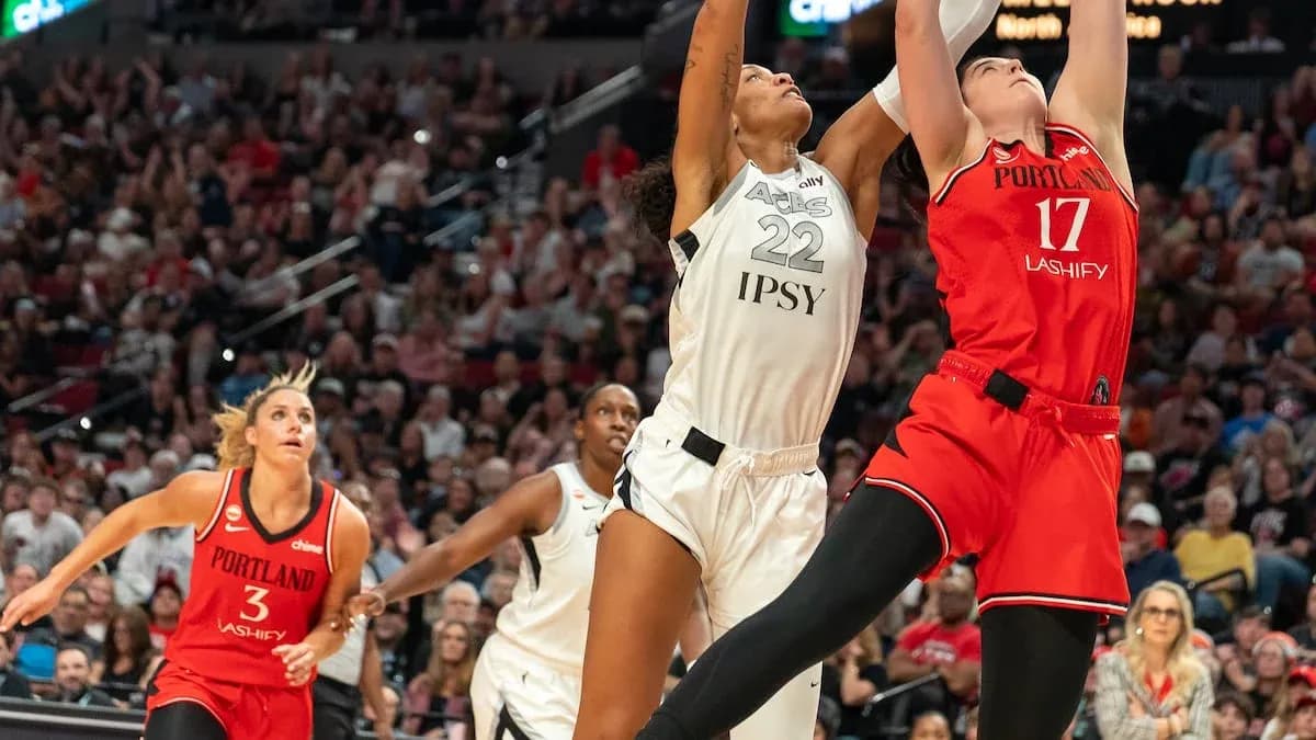 Two players jumping for the basketball during game Two players jumping for the basketball during game