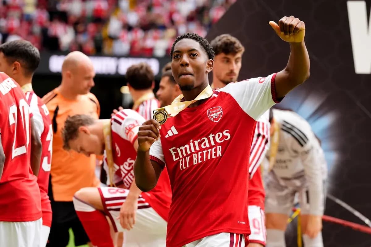 Arsenal player celebrating with a medal Arsenal player celebrating with a medal