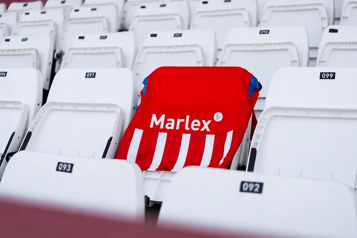Red and white striped jersey on empty stadium seat Red and white striped jersey on empty stadium seat