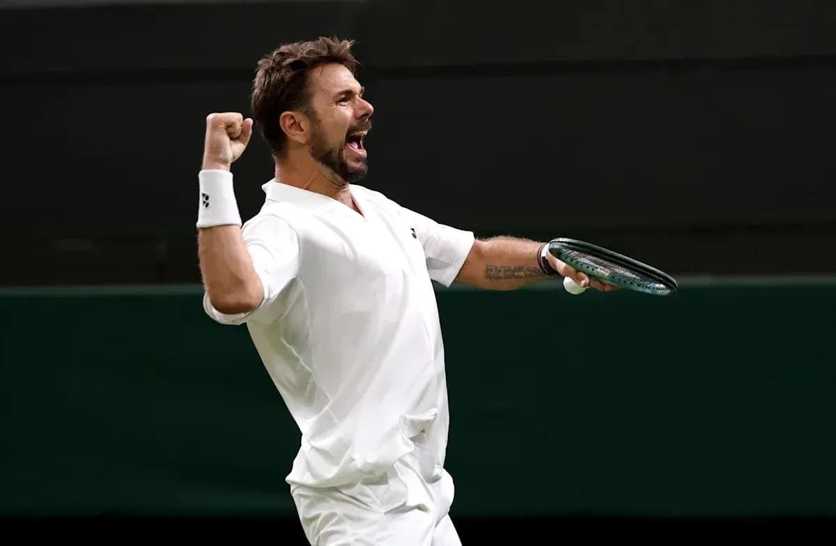 Tennis player celebrating victory with raised fist Tennis player celebrating victory with raised fist