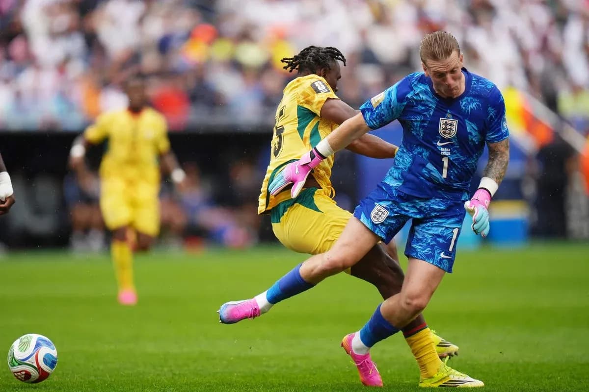 Goalkeeper and player colliding during football match Goalkeeper and player colliding during football match