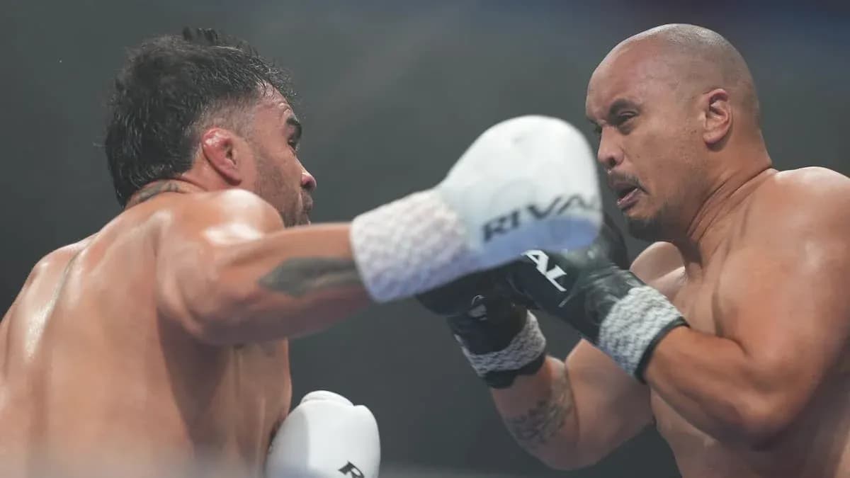Two boxers exchanging punches in the ring Two boxers exchanging punches in the ring
