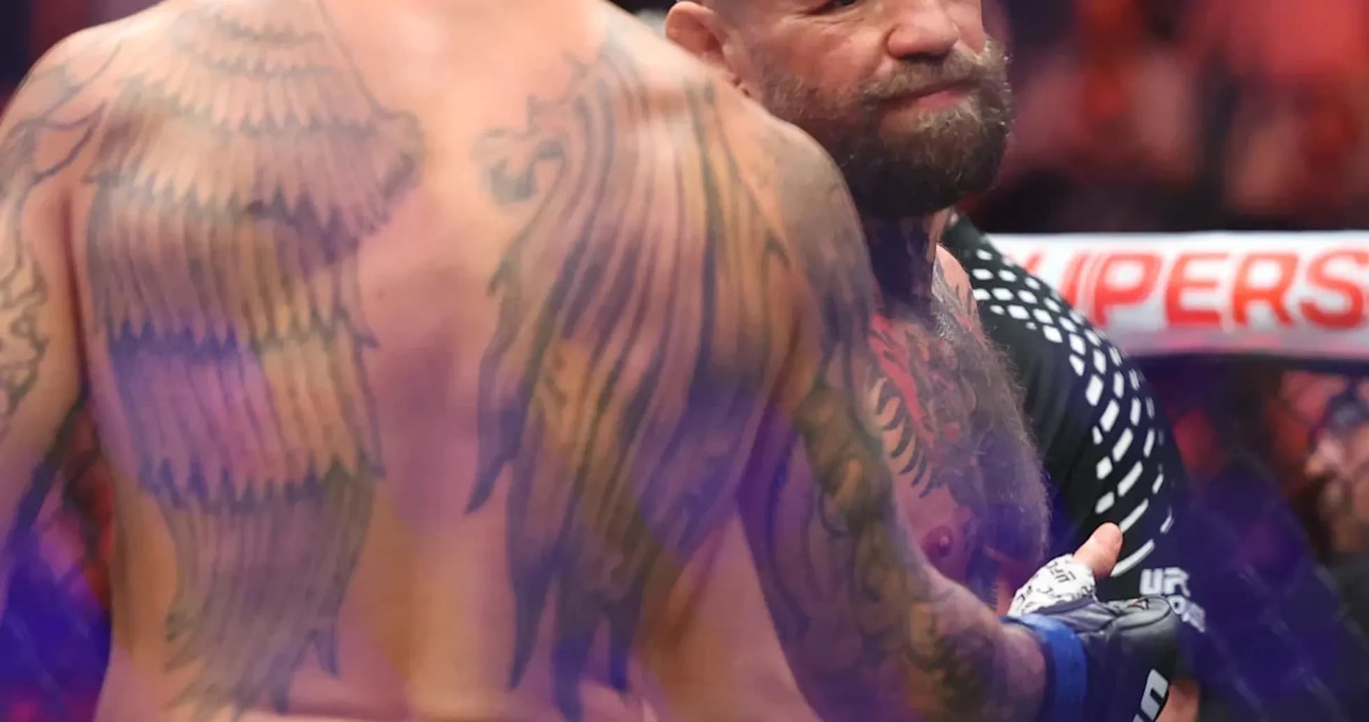 MMA fighters interacting in the octagon after match MMA fighters interacting in the octagon after match